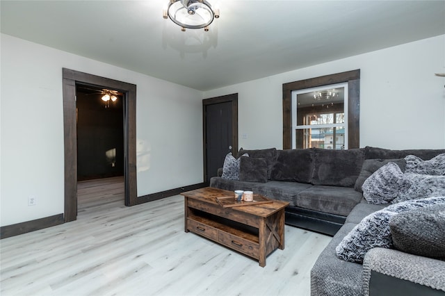 living room with ceiling fan and light hardwood / wood-style flooring