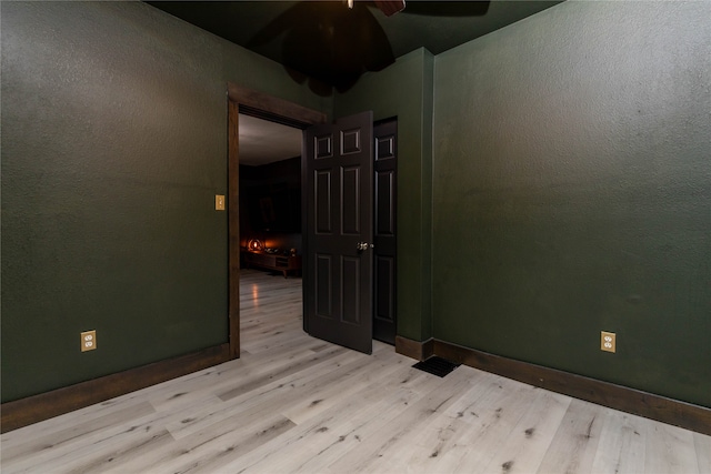 spare room featuring ceiling fan and light hardwood / wood-style flooring