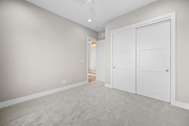 unfurnished bedroom with ceiling fan, a closet, and carpet floors