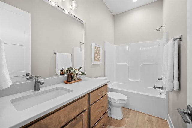 full bathroom with toilet, tub / shower combination, vanity, and hardwood / wood-style flooring