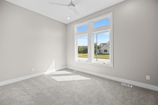 empty room with ceiling fan and carpet flooring