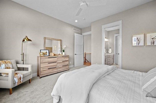 carpeted bedroom featuring connected bathroom and ceiling fan