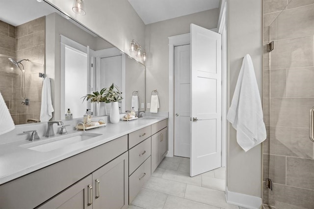 bathroom featuring tile patterned flooring, vanity, and a shower with door