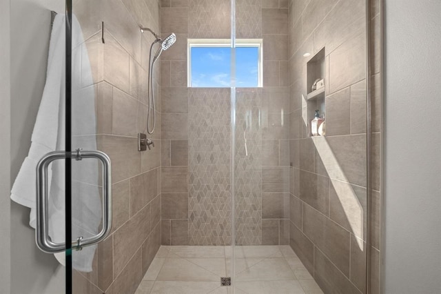 bathroom with a shower with door