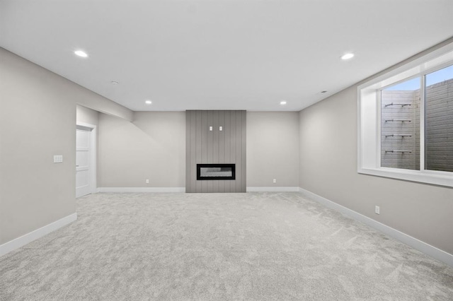 unfurnished living room featuring a fireplace and light carpet