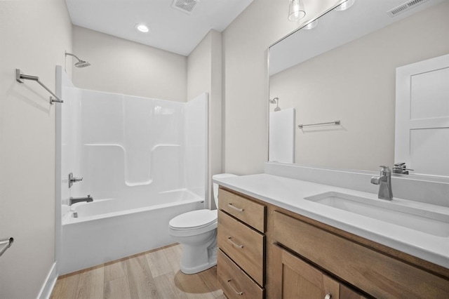 full bathroom with hardwood / wood-style floors, shower / bath combination, toilet, and vanity