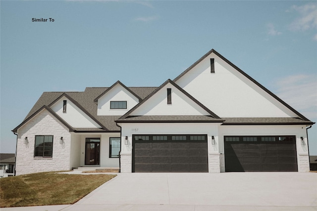 view of front of property featuring a garage and a front yard