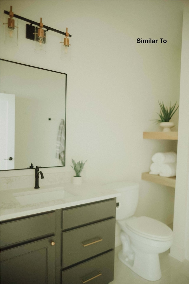 bathroom featuring toilet, vanity, and tile patterned floors