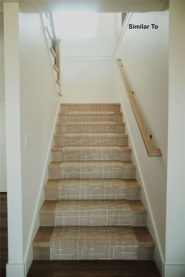 stairway featuring wood-type flooring