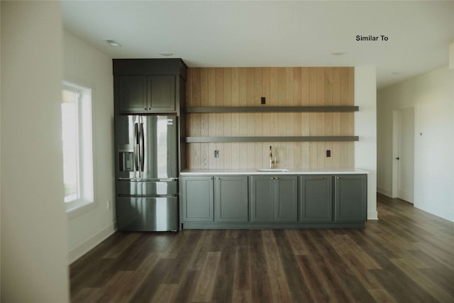 kitchen featuring dark wood-type flooring, stainless steel fridge, gray cabinetry, and a healthy amount of sunlight