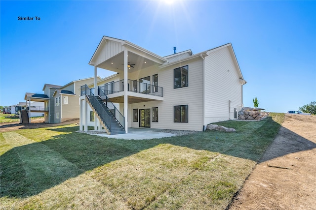 back of house featuring ceiling fan, a patio, a yard, and a deck