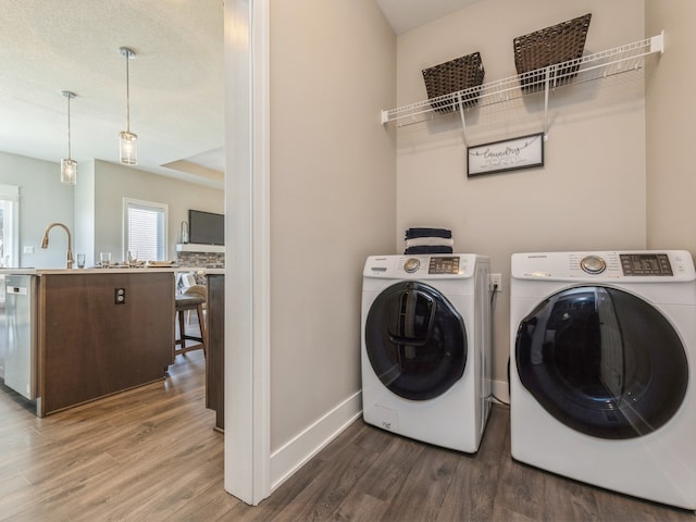 washroom with wood-type flooring and separate washer and dryer