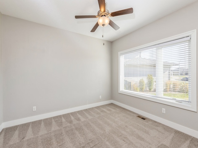 empty room with light colored carpet and ceiling fan