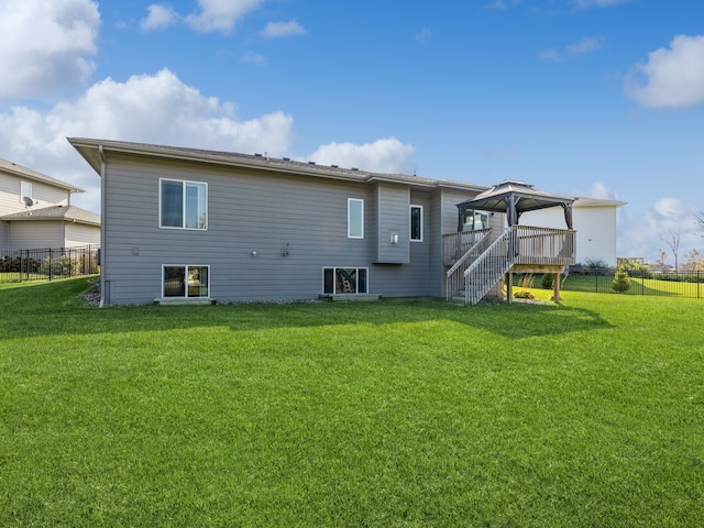 back of house with a yard, a gazebo, and a deck