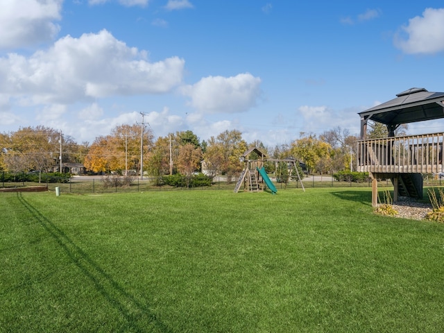 view of yard featuring a playground, a gazebo, and a wooden deck