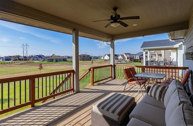 wooden terrace featuring outdoor lounge area, a yard, a residential view, and ceiling fan