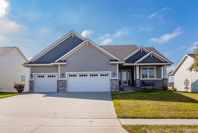 craftsman house featuring a front yard and a garage