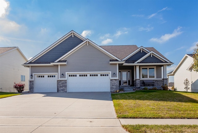 craftsman house with a front lawn, an attached garage, and driveway