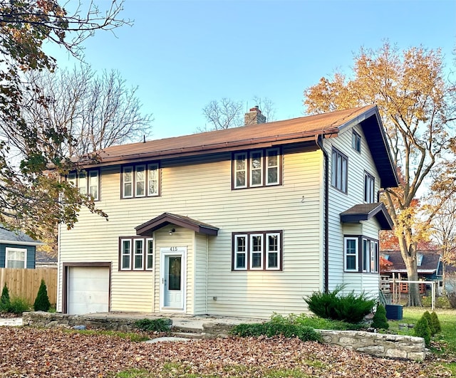 view of front of home featuring a garage and central AC