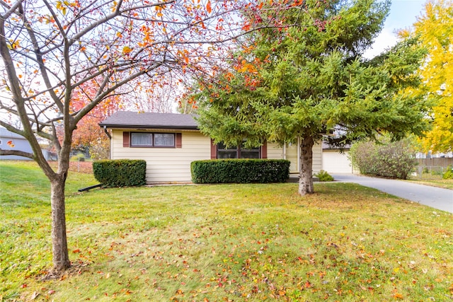 view of front of house with a garage and a front lawn