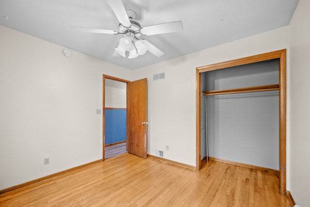 unfurnished bedroom with a closet, light hardwood / wood-style flooring, and ceiling fan