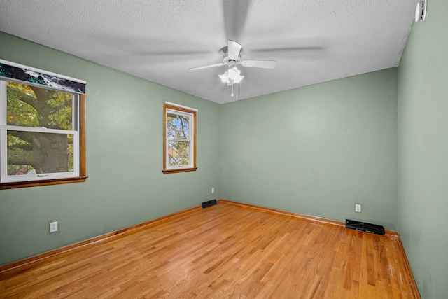 unfurnished room featuring ceiling fan, a textured ceiling, and light hardwood / wood-style flooring