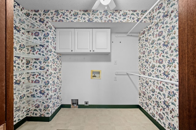 laundry area featuring cabinets, washer hookup, ceiling fan, a textured ceiling, and hookup for an electric dryer