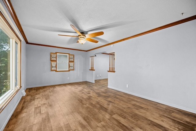 spare room featuring crown molding, hardwood / wood-style floors, ceiling fan, and a textured ceiling