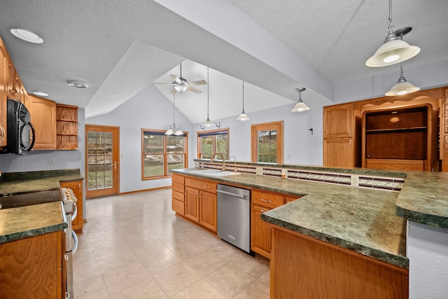 kitchen featuring lofted ceiling, sink, hanging light fixtures, ceiling fan, and stainless steel appliances