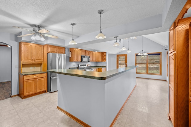 kitchen with appliances with stainless steel finishes, a textured ceiling, ceiling fan, a center island, and hanging light fixtures