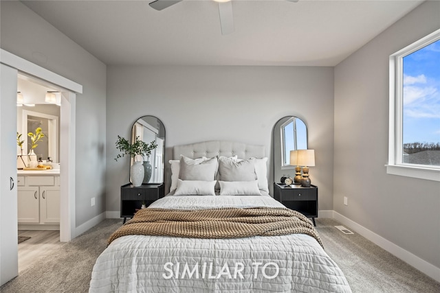 carpeted bedroom featuring ceiling fan and ensuite bathroom