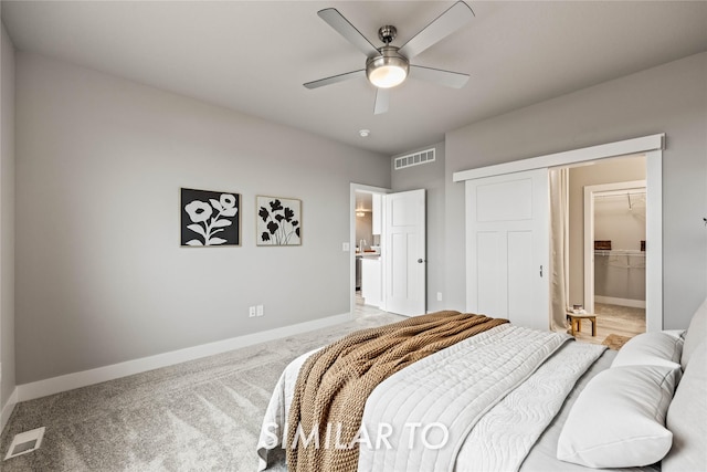 bedroom featuring ceiling fan, a spacious closet, carpet floors, and a closet