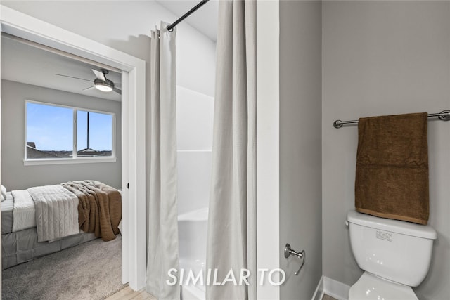 bathroom with walk in shower, ceiling fan, and toilet