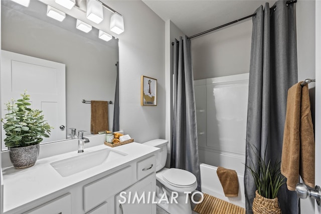 full bathroom featuring shower / tub combo with curtain, vanity, and toilet