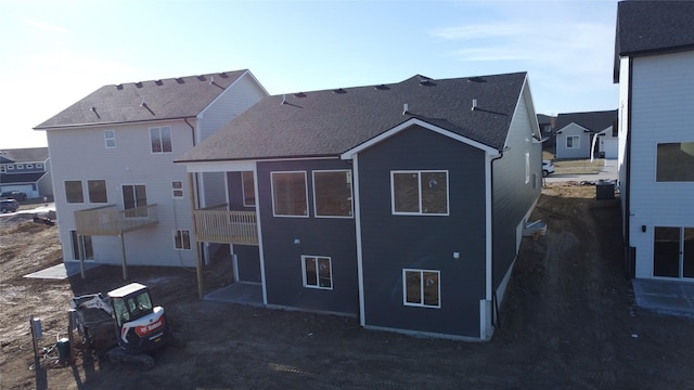 back of house with central air condition unit