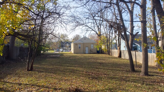 view of yard featuring fence and a residential view