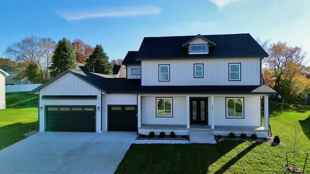 view of front of house with a front yard and a garage