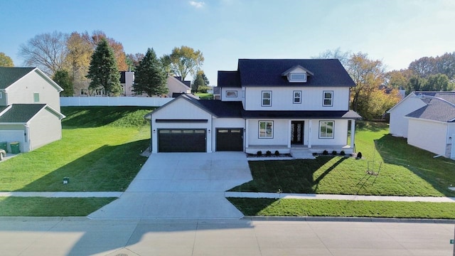 view of front of property featuring a front yard and a garage