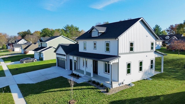 view of front of house with central AC unit, a front yard, covered porch, and a garage