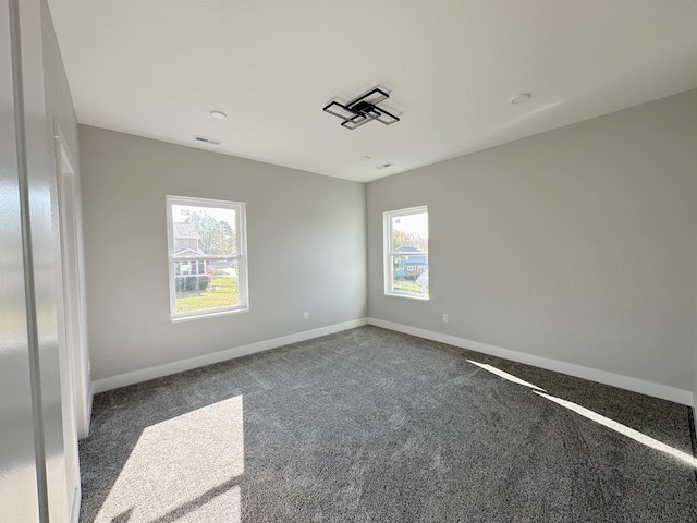 empty room featuring dark carpet