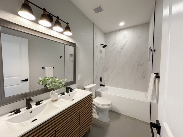 full bathroom with toilet, vanity, tiled shower / bath, and tile patterned flooring