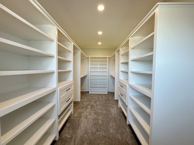 spacious closet featuring dark carpet