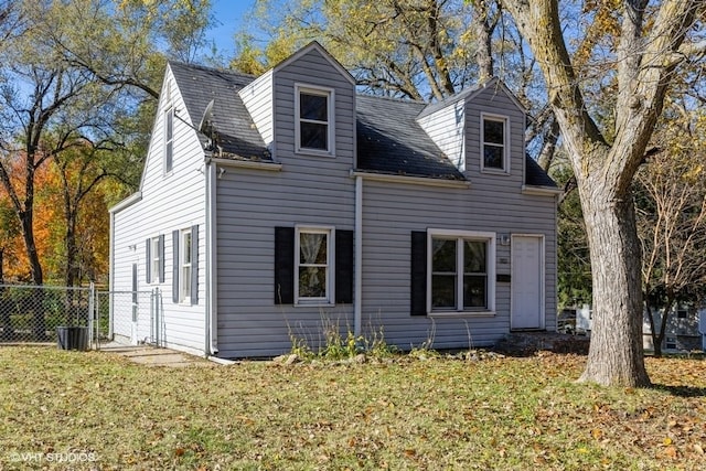 rear view of property featuring a lawn