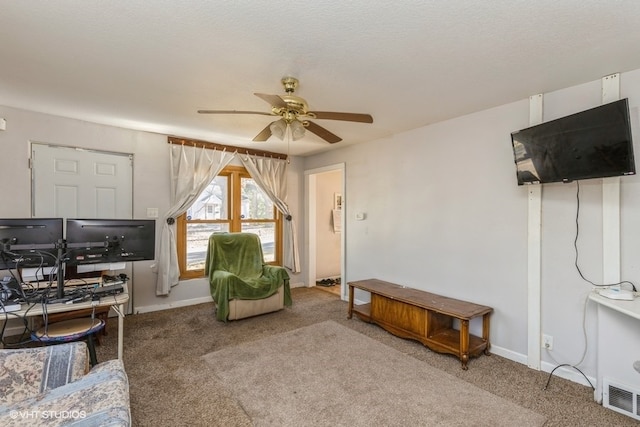 living room with a textured ceiling, carpet, and ceiling fan