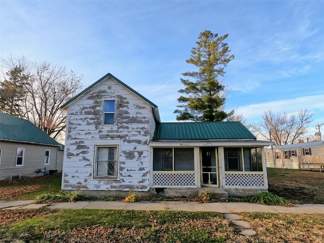 view of front facade with a sunroom