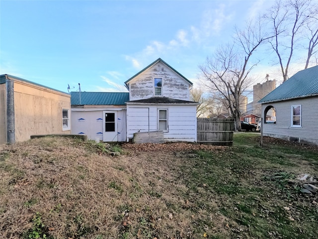 rear view of property featuring a yard