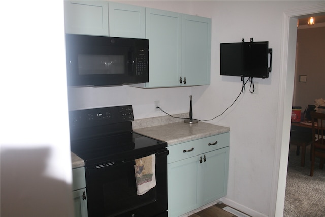 kitchen with black appliances and dark carpet