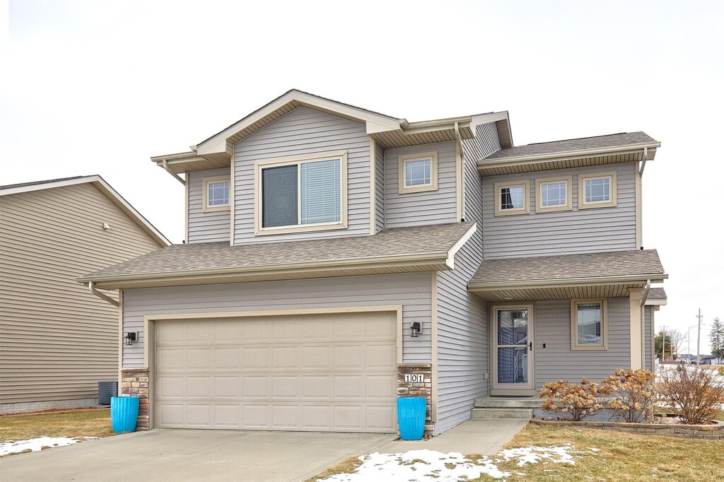 view of front of house featuring a garage and central air condition unit