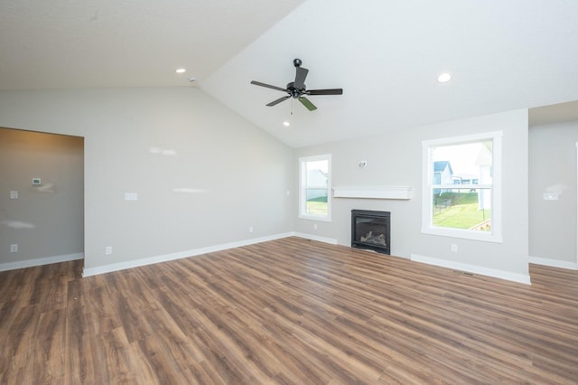 2640 Abbott Dr, Waukee, IA 50263 - unfurnished living room featuring wood finished floors, vaulted ceiling, a glass covered fireplace, ceiling fan, and recessed lighting