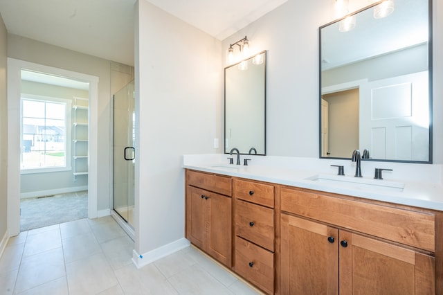 bathroom with tile patterned flooring, an enclosed shower, and vanity